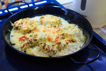 Baked fish with cheese and vegetables. 