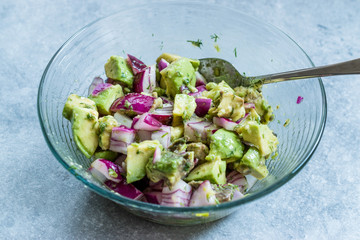 Avocado Salad with Red Onions in Glass Bowl.