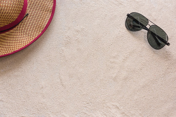 A man hat and sunglasses copy space on the beach sand background