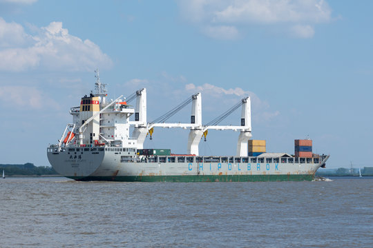 Stade, Germany - May 18, 2019: General cargo ship Chipolbrok Atlantic on Elbe river heading to Hamburg. Chipolbrok is the oldest Chinese deep-sea shipowner and the first enterprise with foreign capita