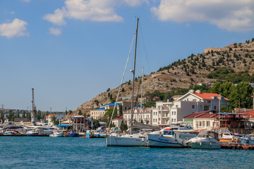 Fototapeta na wymiar Balaklava bay in summer in sunny weather. Crimea, Russia. A lot of boats and ships. Bay for boats.