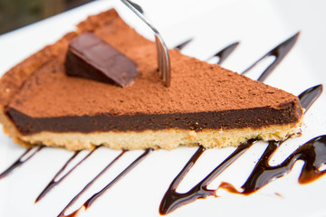 Truffle filling Tart portion decorated with cocoa powder and chocolate