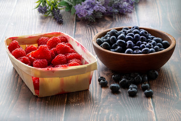 Gifts of the summer garden, raspberries and blueberries. Vitamins and summer