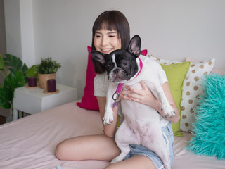 Women hugging dogs on the bed