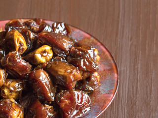 Delicious organic sweet dates in bowl with syrup. 
