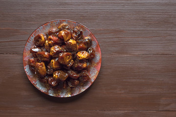 Delicious organic sweet dates in bowl with syrup. 