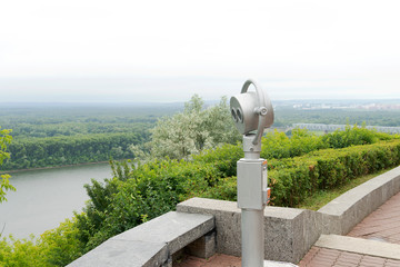 Paid binoculars for exploring the city close-up. Observation deck for exploring the city. Silver color