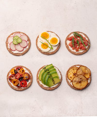 crostini with different toppings on a light background