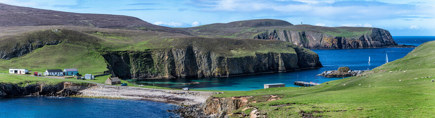 Fototapeta na wymiar Wide panorama of Fair Isle in Scotland at the sunny day