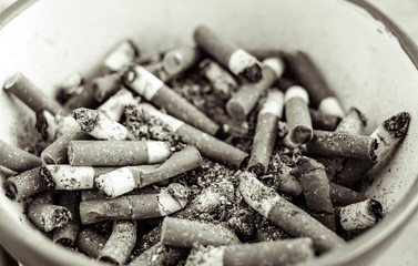 cigarette butts in ceramic bowl