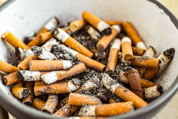 cigarette butts in ceramic bowl