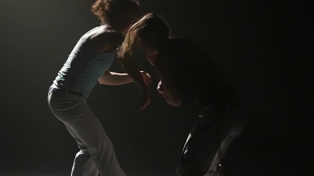 Beautiful females performing incredibly complex of martial art of capoeira.