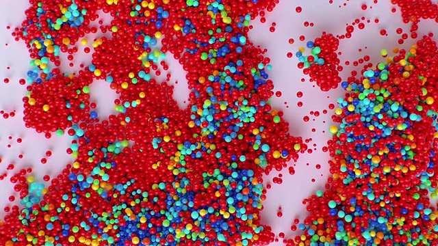 Creative motion graphics footage with 3D colorful bubbles multiplying in virtual space against pink background