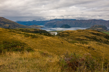 A distant view Lake Wanaka and the surronding hills and lakes taken from the top of the Diamond Lake trail.