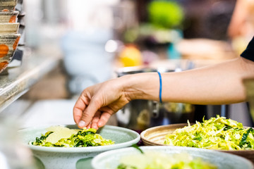 Woman eating salad in restaurant