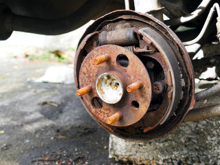 Close-up photos of car wheels that are rusted in the car cemetery.