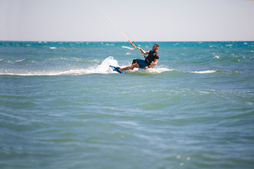 Obraz premium Kitesurfing. Man rides on kite on waves