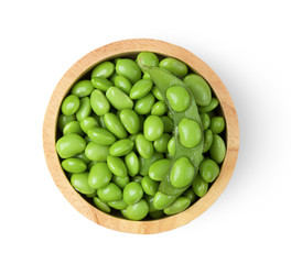 Green soy beans in wood bowl isolated on white background top view.