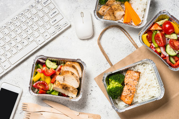 Food delivery concept - healthy lunch in boxes in the office.