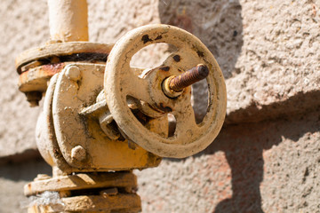 old rusty wheel on a wall