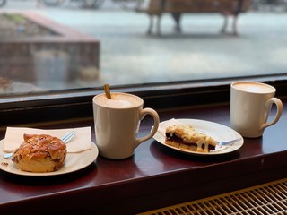 cup of coffee and croissant on table