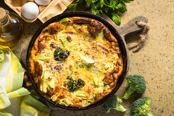 Frittata with sausage and vegetables in skillet.