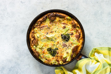 Frittata with sausage and vegetables in skillet.