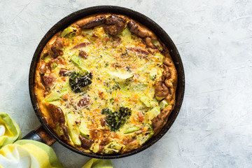 Frittata with sausage and vegetables in skillet.