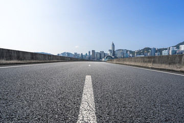 Fototapeta premium empty road with city skyline