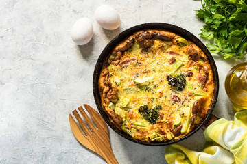 Frittata with sausage and vegetables in skillet.