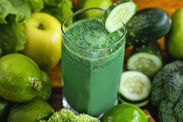 Green smoothie with ingredients on wood table, healthy food concept. Diet or regimen concept.