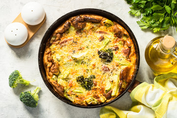 Frittata with sausage and vegetables in skillet.