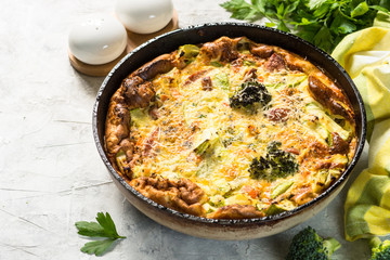 Frittata with sausage and vegetables in skillet.