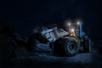 Mining wheel loader Scooping Gravel on a night time construction project - Powered by Adobe