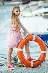 Fashionable teenager girl by the sea. Children's fashion. 