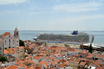 Cruise ship, terracotta roofs and white buildings of Alfama - Lisbon’s oldest area. Lisbon, Portugal