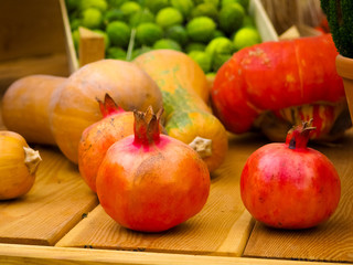 Ripe pomegranate fruits on the wooden background.