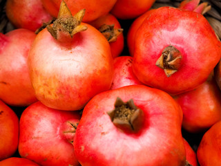 Ripe pomegranate fruits on the wooden background.