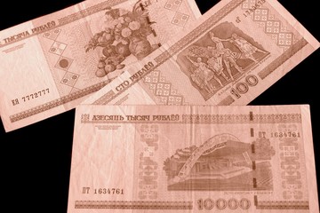 Outdated Belarusian rubles on black background close up brown color toned
