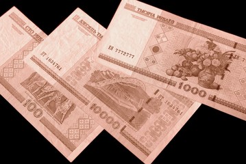 Outdated Belarusian rubles on black background close up brown color toned