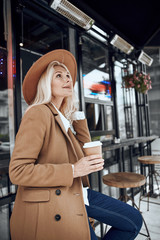Woman with coffee looking up stock photo