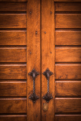 Old door handle on a wooden door