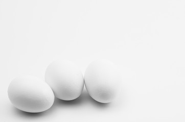 white eggs on a white background - natural shapes backdrop