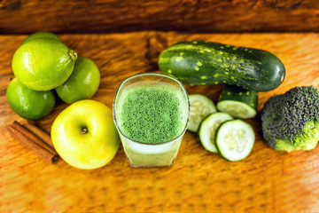 Green detox juice, kale leaves, lemon, apple, lettuce, cucumber, lime and other green vegetables. Copy space. Vegetarian juice, alkaline food concept. Healthy life. Copy space Raw, vegan, vegetarian.