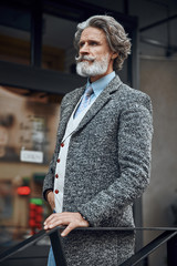 Serious man waiting by the banister stock photo