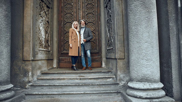 Positive mature couple near the door stock photo