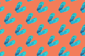 Colorful pattern of green flip flops isolated on red background
