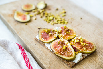 Crispbread with Fig, Ricotta Cheese, Pistachio and Honey Ready to Eat.