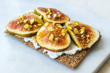 Crispbread with Fig, Ricotta Cheese, Pistachio and Honey Ready to Eat.
