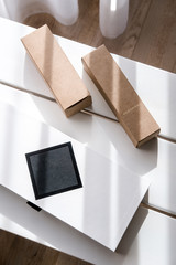 Set of three long package boxes in brown craft paper and white and black boxes. Overhead. Beauty, fashion blogging, minimalism concept